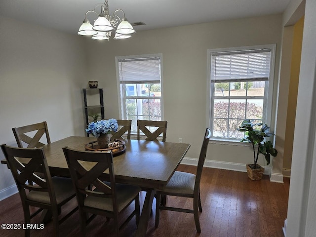 dining space featuring a chandelier and dark wood-type flooring