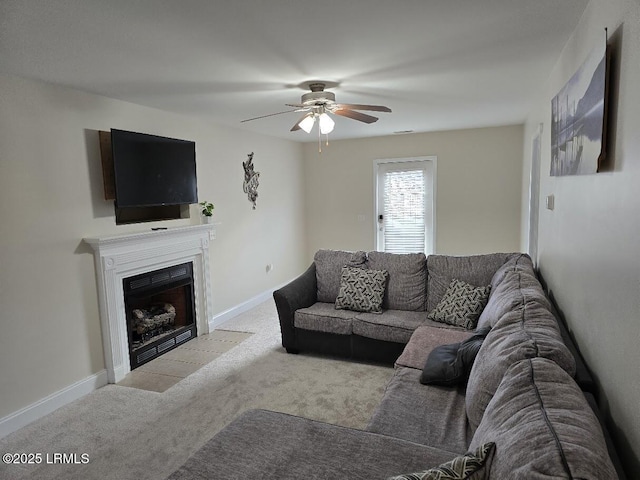 carpeted living room with ceiling fan