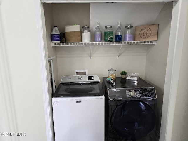 washroom featuring washing machine and clothes dryer