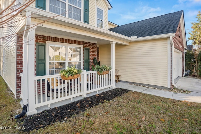 view of exterior entry with covered porch