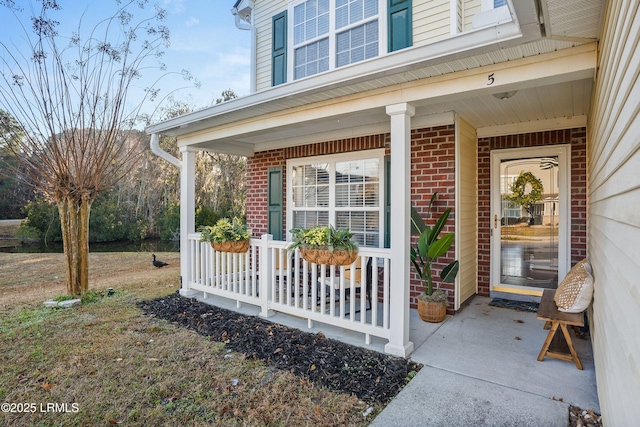 view of exterior entry featuring a porch