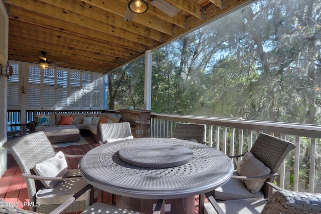 wooden deck featuring an outdoor living space and ceiling fan