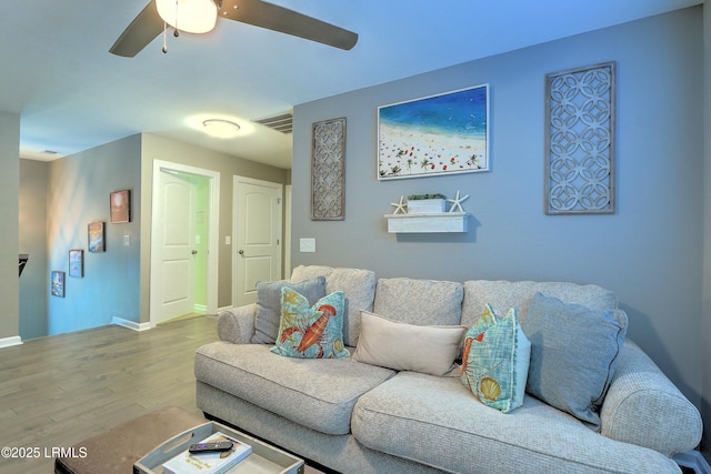 living room with light hardwood / wood-style floors and ceiling fan