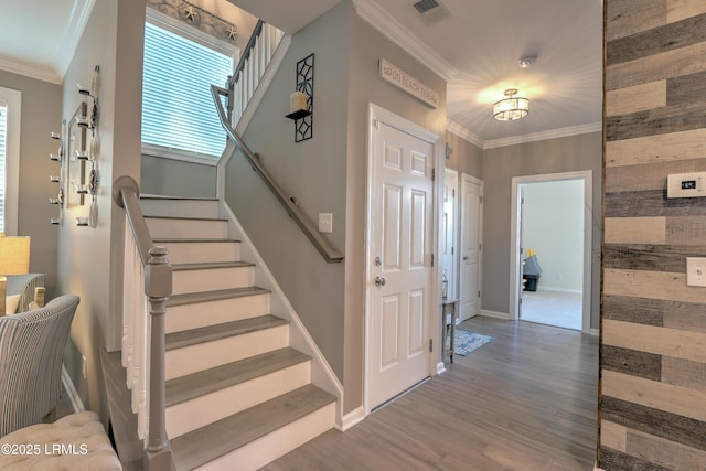 foyer featuring ornamental molding and wood-type flooring