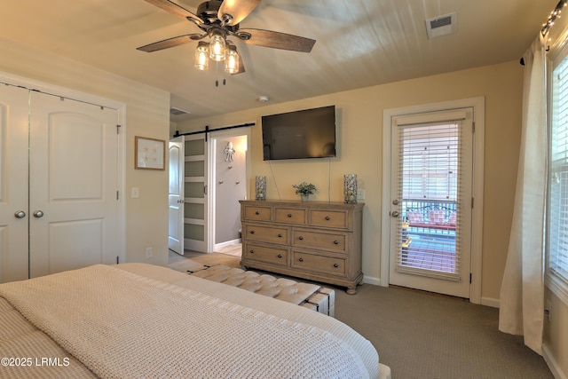 bedroom with light colored carpet, access to exterior, ceiling fan, a barn door, and a closet