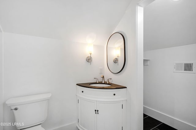 half bath with vanity, toilet, tile patterned floors, baseboards, and visible vents