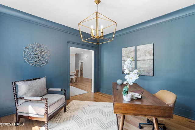 office space with baseboards, a chandelier, and wood finished floors