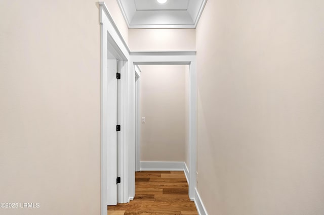 hallway featuring light wood-type flooring and baseboards