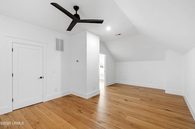 bonus room featuring a ceiling fan, visible vents, vaulted ceiling, baseboards, and light wood-style floors