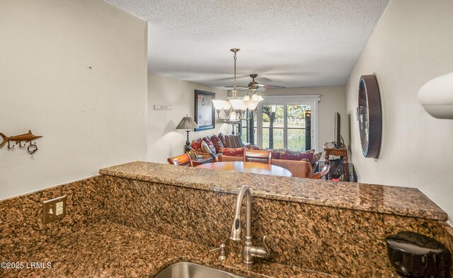 kitchen featuring ceiling fan and a textured ceiling