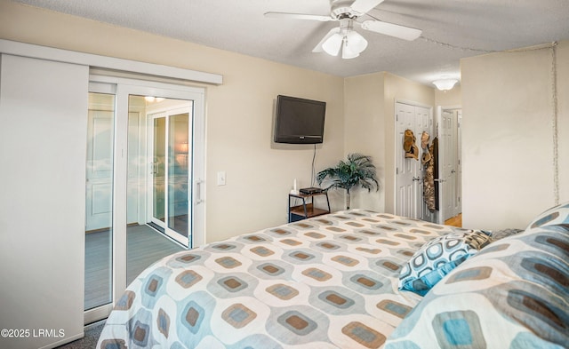 bedroom featuring access to exterior, a textured ceiling, dark wood-type flooring, and ceiling fan