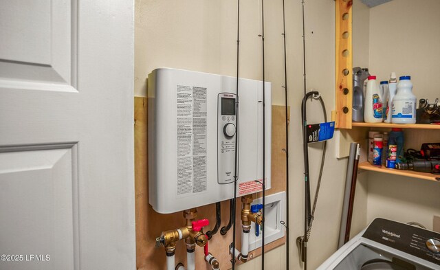 utility room featuring washer / dryer and water heater