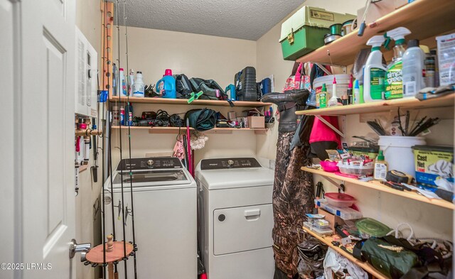 laundry area with washing machine and dryer and a textured ceiling