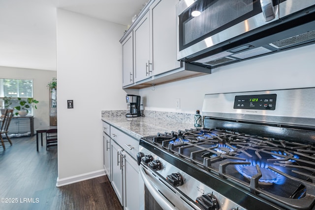 156 Teal Bluff Blvd, Seabrook, SC 29940 - kitchen with appliances with stainless steel finishes, dark wood-style flooring, light stone counters, and baseboards