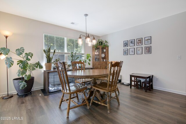 156 Teal Bluff Blvd, Seabrook, SC 29940 - dining room with dark wood-style flooring, a chandelier, and baseboards