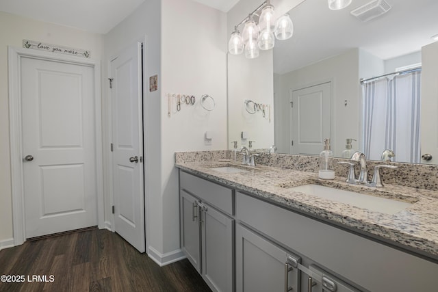156 Teal Bluff Blvd, Seabrook, SC 29940 - full bathroom featuring wood finished floors, baseboards, and double vanity