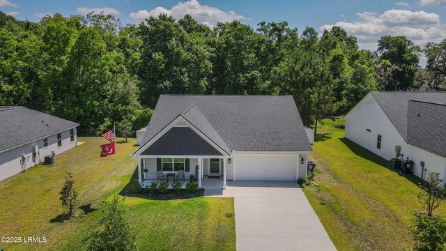 156 Teal Bluff Blvd, Seabrook, SC 29940 - view of front of property featuring covered porch, concrete driveway, an attached garage, and a front yard