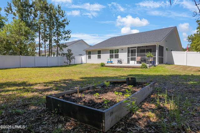 156 Teal Bluff Blvd, Seabrook, SC 29940 - back of property featuring a vegetable garden, a sunroom, and a shingled roof