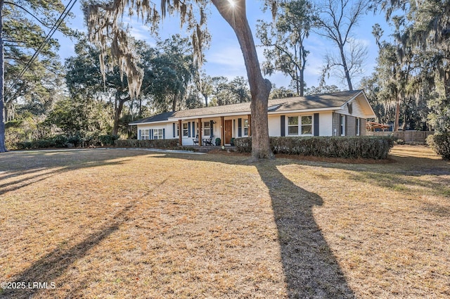 ranch-style house featuring a porch and a front lawn