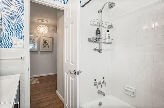 bathroom with tiled shower / bath, hardwood / wood-style floors, and vanity