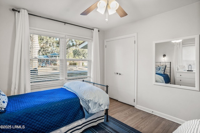 bedroom with hardwood / wood-style flooring and ceiling fan