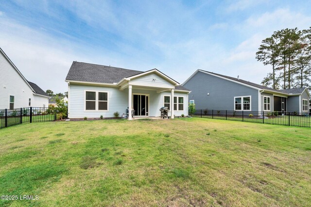 rear view of house with a yard and a patio