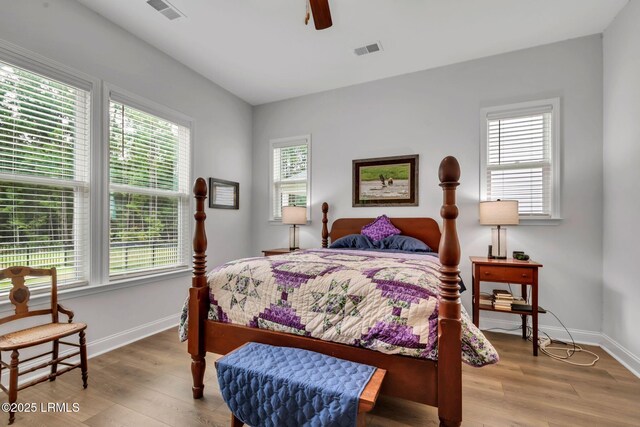 bedroom featuring ceiling fan, ensuite bathroom, and hardwood / wood-style floors