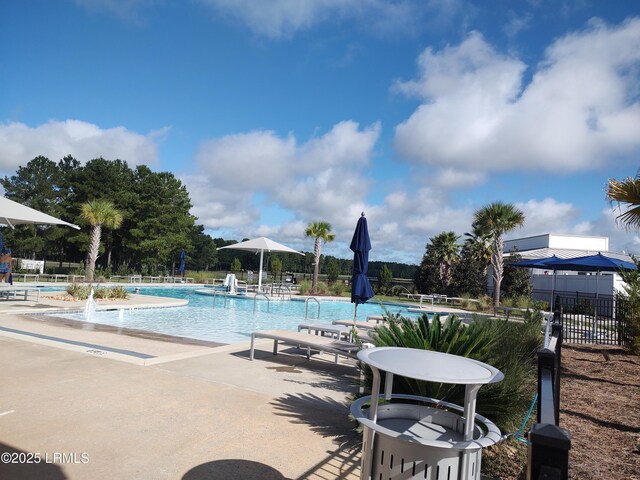 view of property's community featuring tennis court