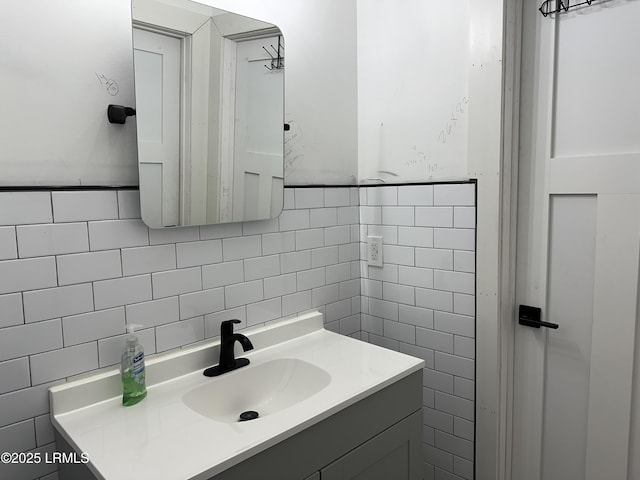 bathroom featuring tile walls and vanity