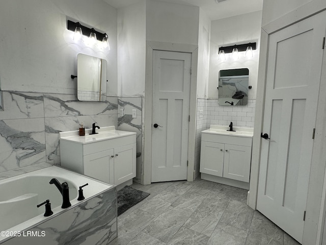 full bathroom featuring a closet, marble finish floor, two vanities, and a sink