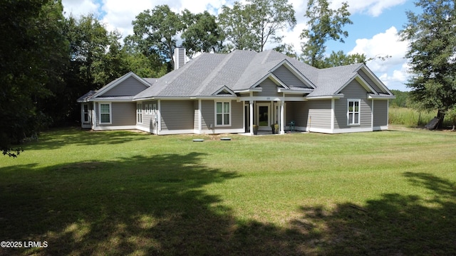 view of front of house with a front yard and a chimney