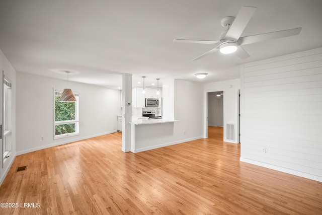 1203 Laudonniere St, Beaufort, SC 29902 - unfurnished living room with light wood-style flooring and ceiling fan