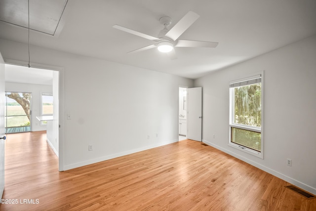 1203 Laudonniere St, Beaufort, SC 29902 - spare room featuring attic access, light wood-style floors, healthy amount of natural light, and a ceiling fan