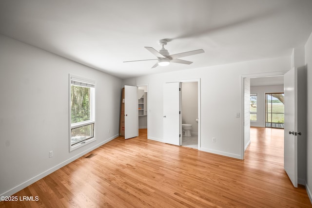 1203 Laudonniere St, Beaufort, SC 29902 - unfurnished bedroom with multiple windows, light wood-style flooring, and connected bathroom