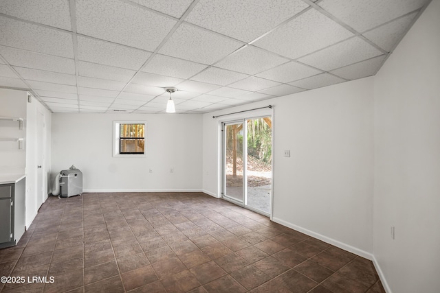 1203 Laudonniere St, Beaufort, SC 29902 - spare room with a paneled ceiling and dark tile patterned floors