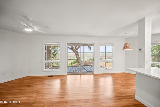 1203 Laudonniere St, Beaufort, SC 29902 - unfurnished living room with light wood-style floors and ceiling fan