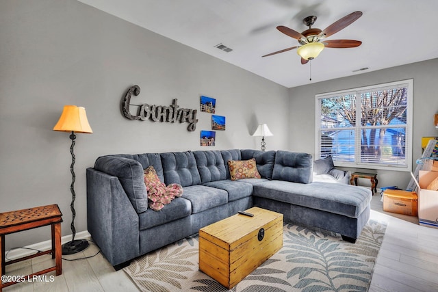 living room with wood-type flooring and ceiling fan