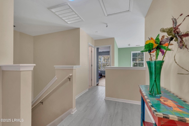 hallway with light hardwood / wood-style floors