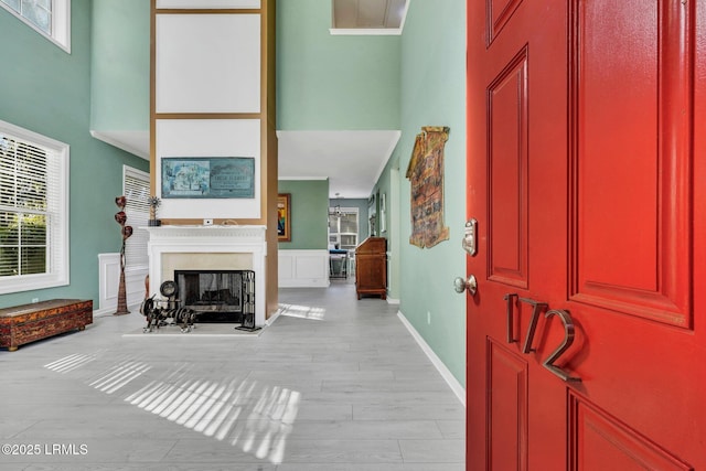 foyer entrance with a towering ceiling and light hardwood / wood-style floors