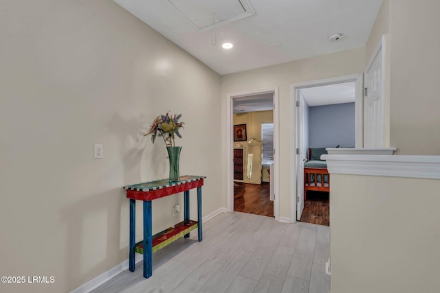 corridor with light hardwood / wood-style floors