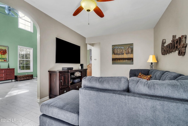 living room featuring light hardwood / wood-style floors and ceiling fan