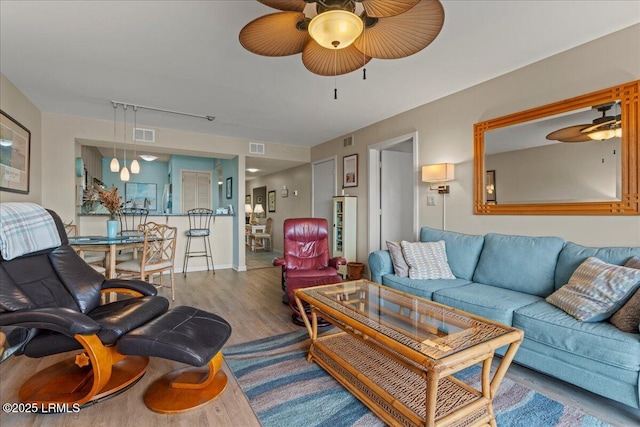 living room with hardwood / wood-style flooring and ceiling fan