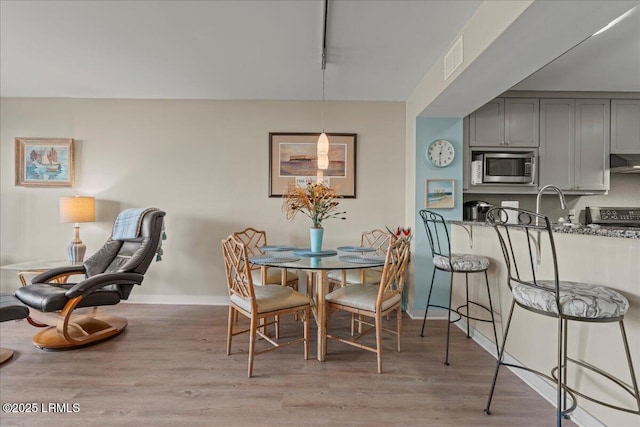 dining space featuring light hardwood / wood-style floors