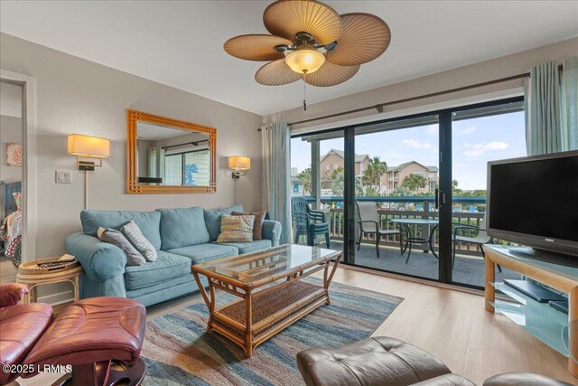 living room featuring hardwood / wood-style flooring and ceiling fan