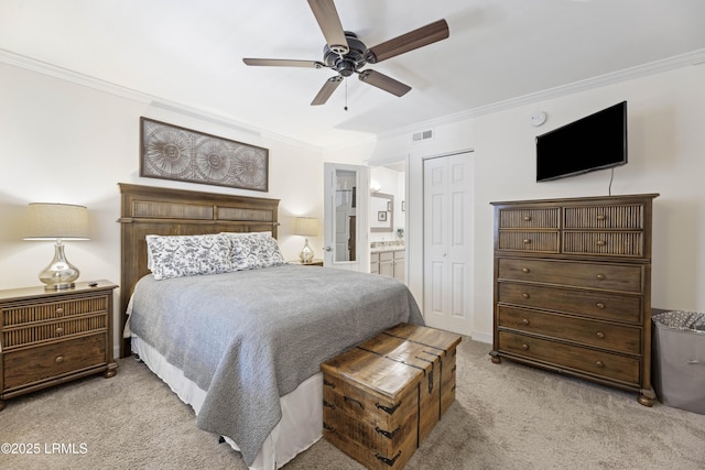 bedroom with crown molding, a closet, light colored carpet, visible vents, and connected bathroom