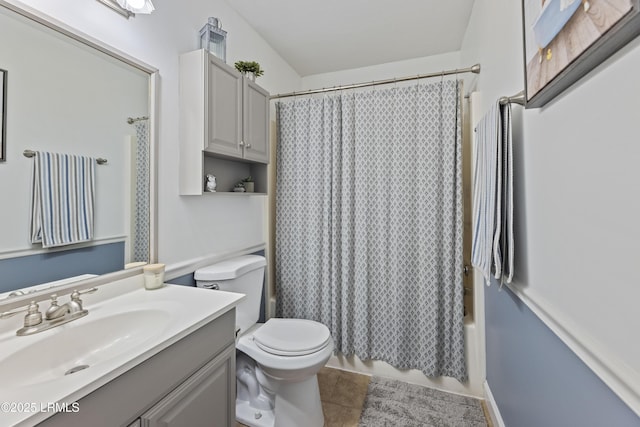 bathroom featuring tile patterned flooring, vanity, toilet, and shower / bath combo