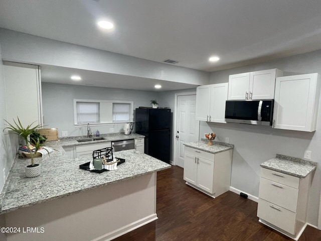 kitchen featuring white cabinetry, appliances with stainless steel finishes, sink, and light stone counters