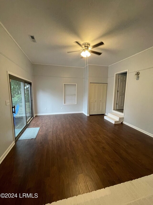 empty room with dark hardwood / wood-style floors and ceiling fan