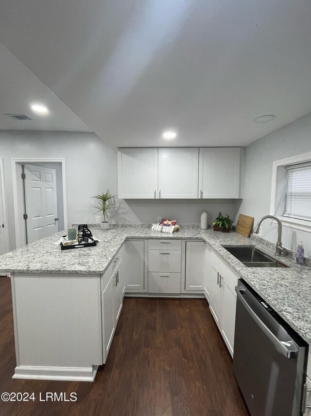 kitchen featuring stainless steel dishwasher, kitchen peninsula, sink, and white cabinets