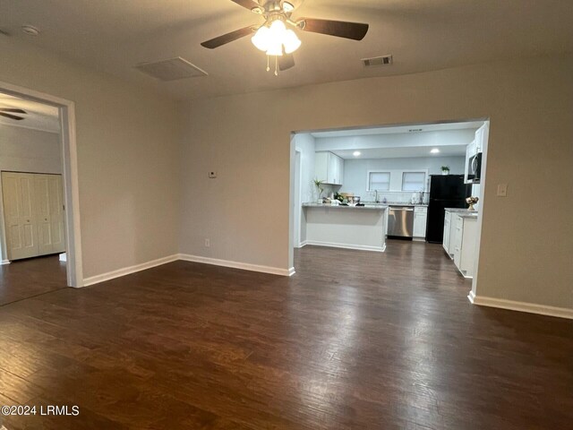 unfurnished living room with ceiling fan and dark hardwood / wood-style flooring